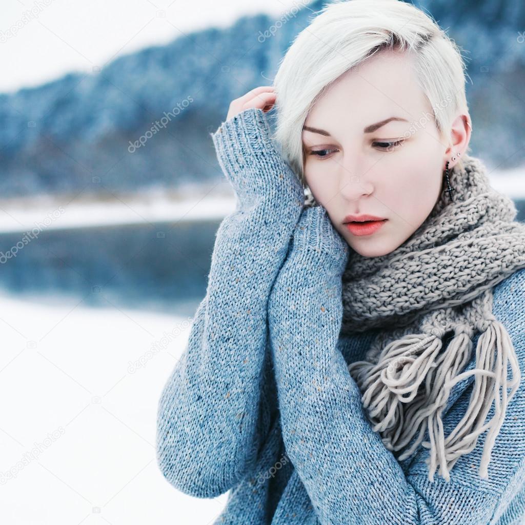 Girl dressed in sweater and scarf.