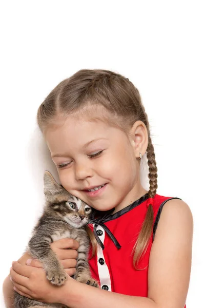 Isolated little girl hugging kitten on white background — Zdjęcie stockowe