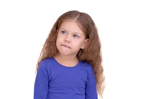 Serious and thinking little girl having a bite lower lip in planning — Stock Photo, Image
