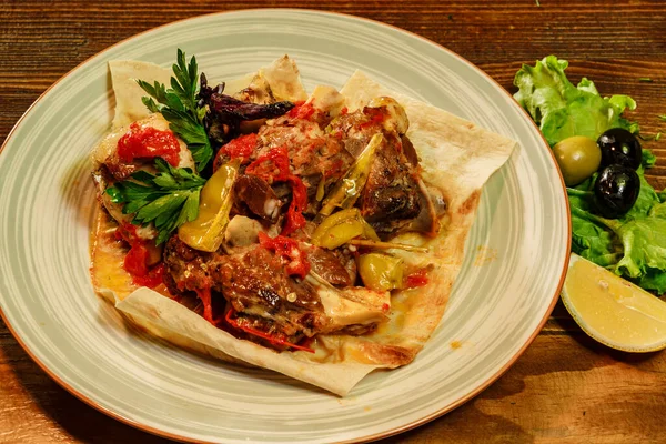 Tasty dish with lamb or sheep meat served with armenian lavash bread and lemon served in restaurant