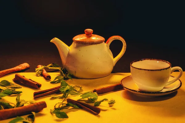 Closeup Cup Tea Teapot Yellow Background Aromatic Cinnamon Some Herbs — Stockfoto