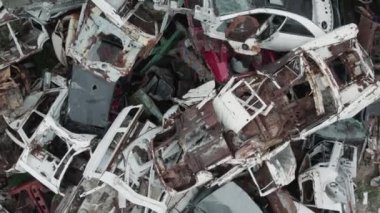 Car scrap yard. Aerial shot, pile of crushed and destroyed cars for recycling purposes