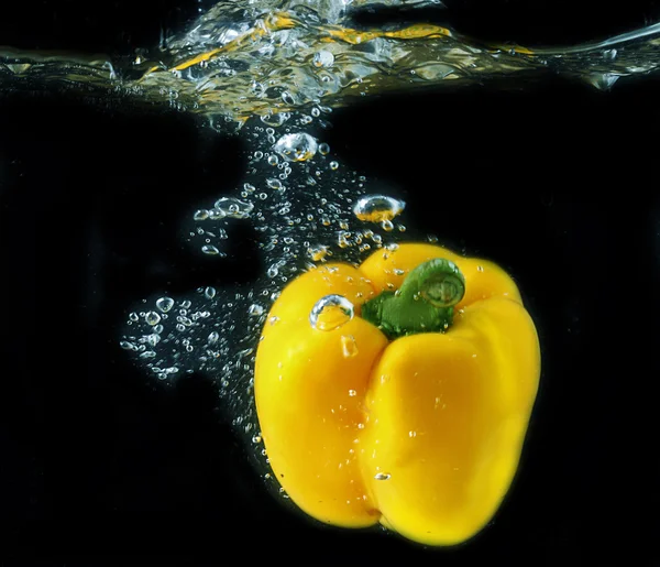 Yellow paprika splashing — Stock Photo, Image