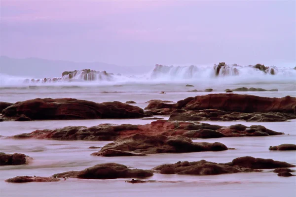 Rocks and the sea waves of sawarna beach, banten, indonesia — стоковое фото