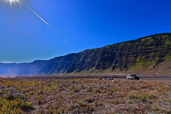 Meadow at bromo, hill back ground, clear blue sky — Stock Photo, Image