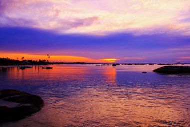sunset at tanjung tinggi beach belitung island clipart