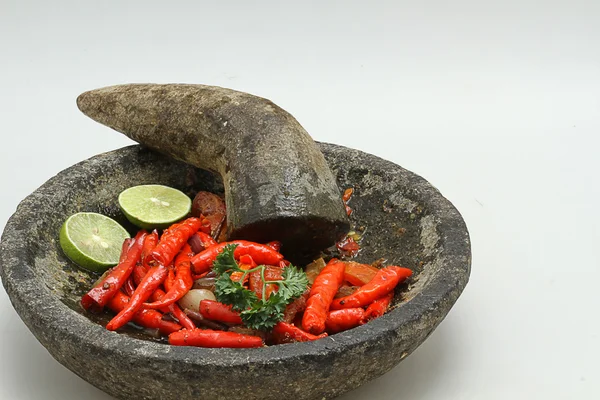 Chili with pestle and mortar, isolated white background — Stock Photo, Image