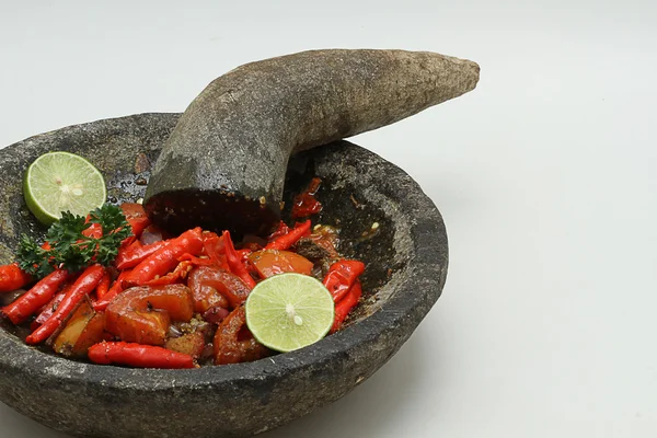 Chili with pestle and mortar, isolated white background — Stock Photo, Image