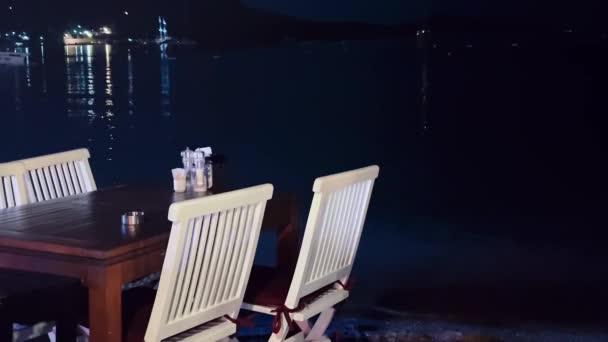 Seascape, jantar fino e conceito de férias, restaurante à beira-mar e reflexos de luzes na água da cidade costeira à noite — Vídeo de Stock