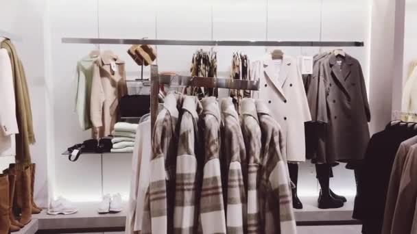 Odzież detaliczna i zrównoważona koncepcja mody. Asortyment luksusowych odzieży damskiej, jesienno-zimowej kolekcji w sklepie masowym marki — Wideo stockowe