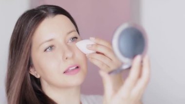 Güzellik blenderi ve ayna uygulayan kadın ya da sıvı pudra, makyaj malzemesi olarak makyaj karıştırıcı sünger, güzel bir modelin yüz portresi, doğal eko ürün ve kozmetik reklamı