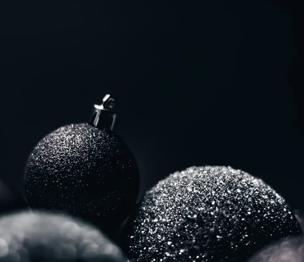 Christmas holiday and festive decoration concept. Black baubles as minimalistic xmas background — Stock Photo, Image