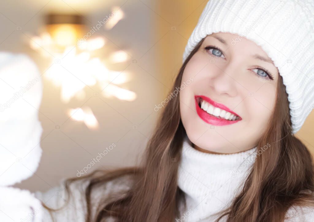Christmas, people and winter holiday concept. Happy smiling woman wearing white knitted hat as closeup face xmas portrait