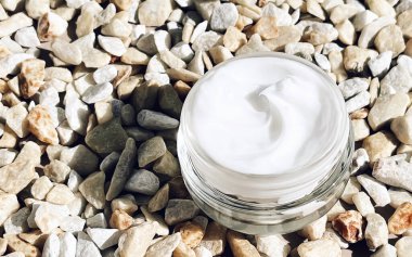 Yüz kremi nemlendirici, arka planda cam kavanoz, cilt bakımı ve kozmetik, güzellik ürünü konsepti.