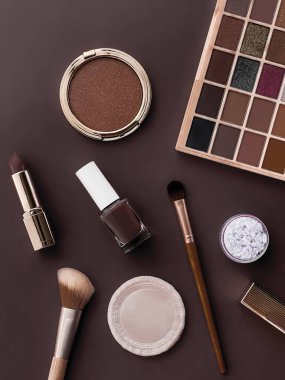 Beauty, make-up and cosmetics flatlay design with copyspace, cosmetic products and makeup tools on brown background, girly and feminine style concept