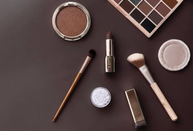 Beauty, make-up and cosmetics flatlay design with copyspace, cosmetic products and makeup tools on brown background, girly and feminine style concept