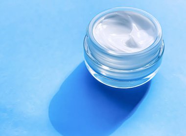 Face cream moisturiser jar as product sample on blue background, beauty and skincare, cosmetic science concept