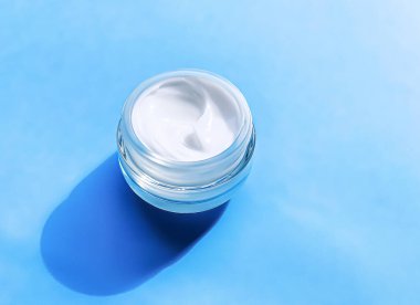 Face cream moisturiser jar as product sample on blue background, beauty and skincare, cosmetic science concept