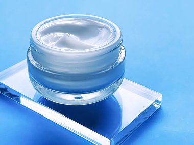 Face cream moisturiser jar on glass and blue background, beauty product and skincare, cosmetic science concept
