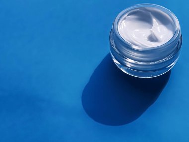 Face cream moisturiser jar as product sample on blue background, beauty and skincare, cosmetic science concept