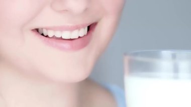 Healthy diet, teeth and dairy drink, perfect natural white toothy female smile and glass of milk closeup