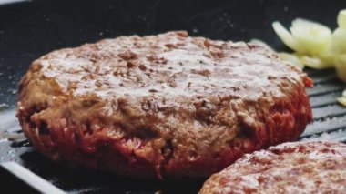 Bahçe konseptinde ızgara et, kızartma tavasında kırmızı et, dökme demir ızgara tavada kıymalı burger pişirmek.