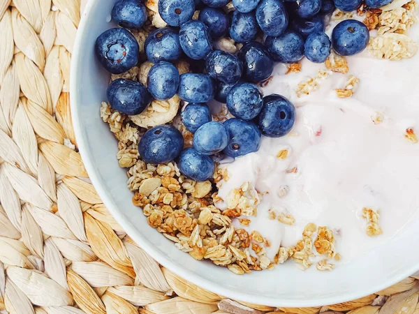 Sağlıklı kahvaltı ve sabah yemeği olarak yaban mersinli yoğurt kasesi, tatlı yemek ve organik meyve, diyet ve beslenme konsepti