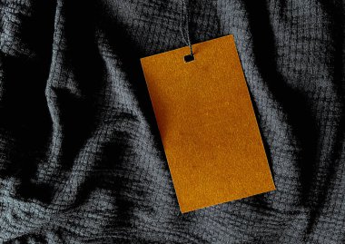 Blank fashion label tag, sale price card on luxury fabric background, shopping and retail concept