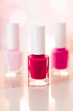 Shades of pink and red nail polish set on glamour background, nailpolish bottles for manicure and pedicure, luxury beauty cosmetics and make-up brand ad