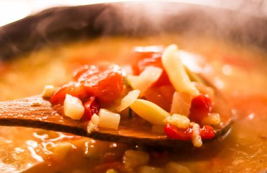 Cooking vegetable soup in saucepan, comfort food and homemade meal concept