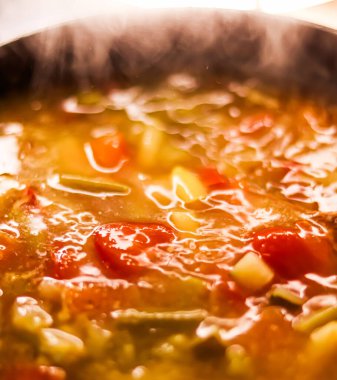 Cooking vegetable soup in saucepan, comfort food and homemade meal concept