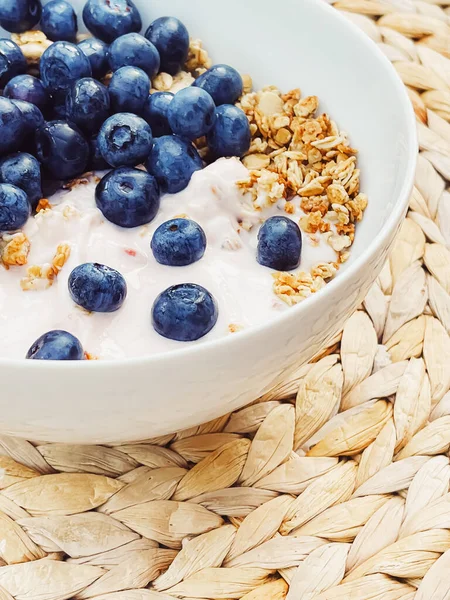Sağlıklı kahvaltı ve sabah yemeği olarak yaban mersinli yoğurt kasesi, tatlı yemek ve organik meyve, diyet ve beslenme konsepti