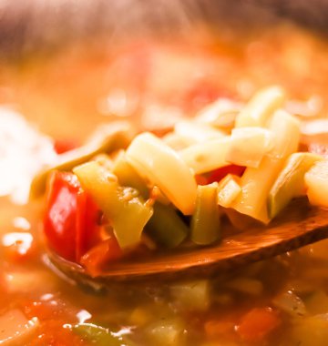 Cooking vegetable soup in saucepan, comfort food and homemade meal concept