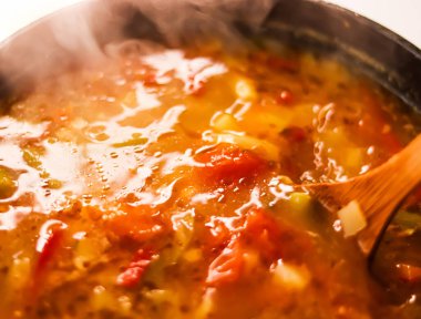 Cooking vegetable soup in saucepan, comfort food and homemade meal concept