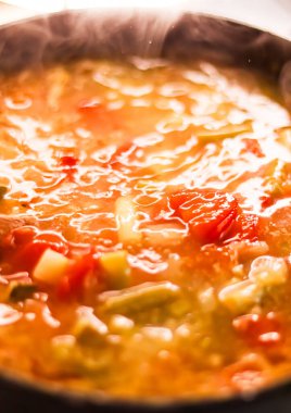 Cooking vegetable soup in saucepan, comfort food and homemade meal concept