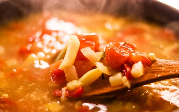 Cooking vegetable soup in saucepan, comfort food and homemade meal concept