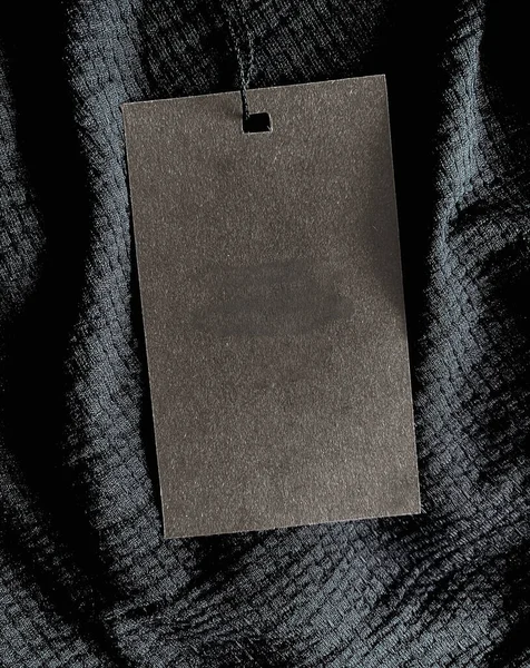 Blank fashion label tag, sale price card on luxury fabric background, shopping and retail concept