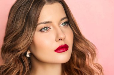 Beauty face portrait, beautiful woman with long wavy hairstyle and chic make-up on pink background, bridal makeup, fashion and glamour model look for skincare, cosmetics and hair care concept