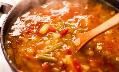 Cooking vegetable soup in saucepan, comfort food and homemade meal concept