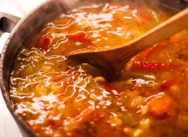 Cooking vegetable soup in saucepan, comfort food and homemade meal concept