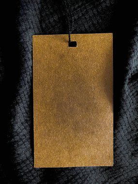 Blank fashion label tag, sale price card on luxury fabric background, shopping and retail concept