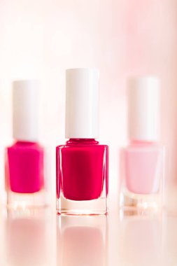 Shades of pink and red nail polish set on glamour background, nailpolish bottles for manicure and pedicure, luxury beauty cosmetics and make-up brand ad