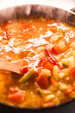Cooking vegetable soup in saucepan, comfort food and homemade meal concept