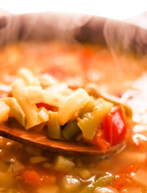 Cooking vegetable soup in saucepan, comfort food and homemade meal concept