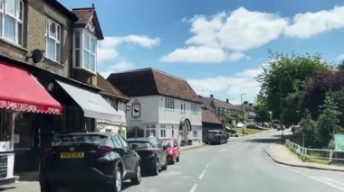 Hertfordshire, England in June 2022: Driving through beautiful English countryside and towns, country living. High quality 4k footage