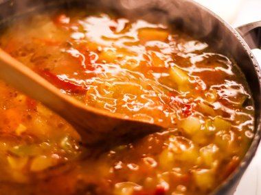 Cooking vegetable soup in saucepan, comfort food and homemade meal concept