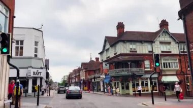 St Albans, Hertfordshire, England in June 2022: Driving in beautiful English town centre street, historic buildings, shops and market. High quality 4k footage