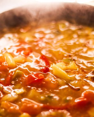 Cooking vegetable soup in saucepan, comfort food and homemade meal concept