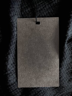 Blank fashion label tag, sale price card on luxury fabric background, shopping and retail concept
