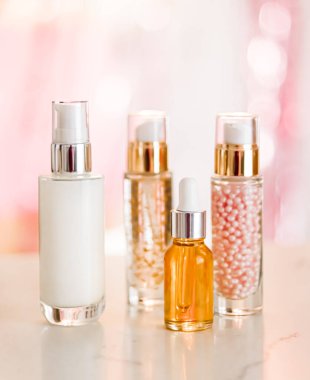 Cilt bakım ürünleri göz kamaştırıcı arka planda, cam şişeler serum, yağ, yüz kremi nemlendirici, yüz losyonu cilt bakımı kozmetik seti, parlak mermer, vücut bakım rutini ve